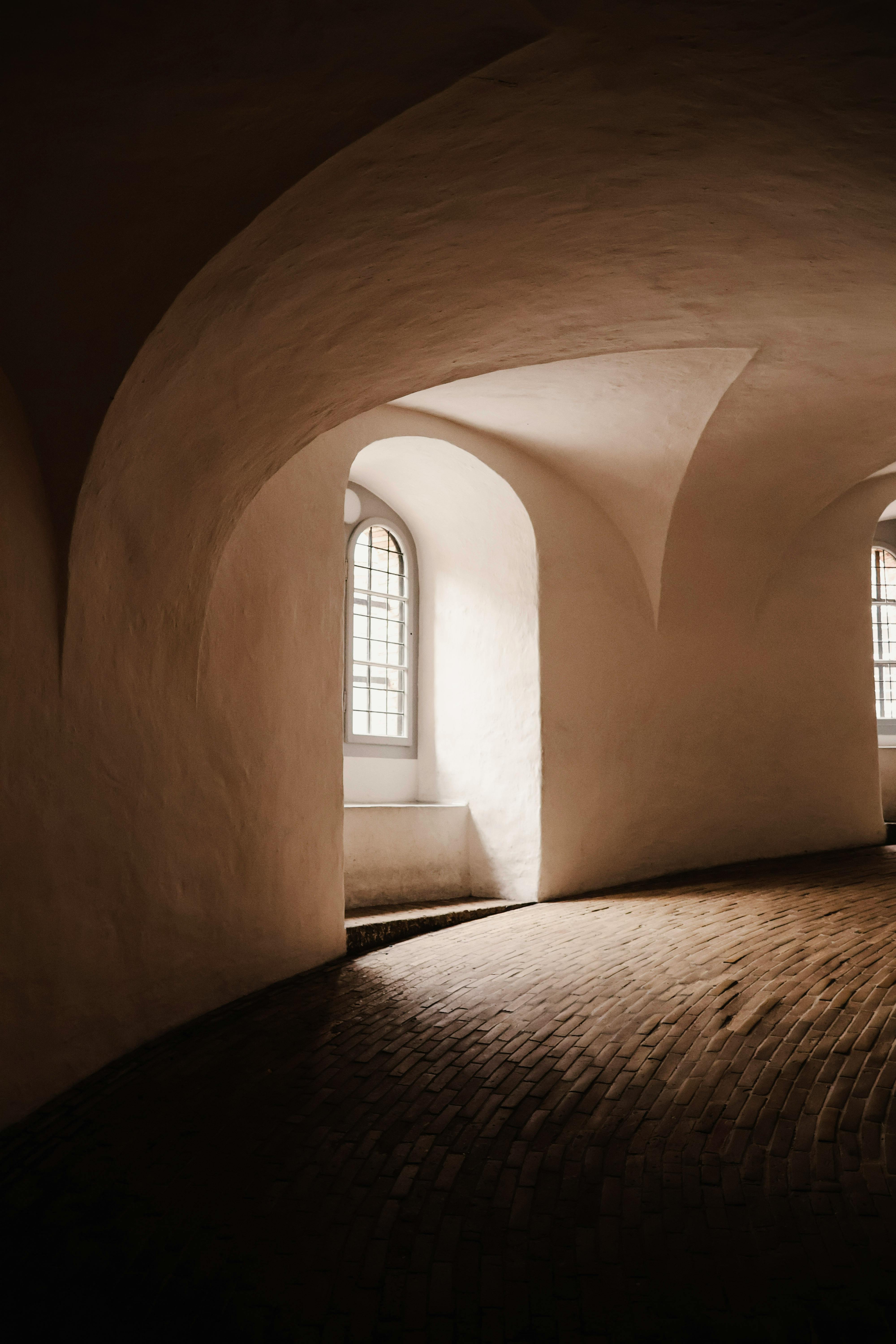 A stunning view of curved architecture and arched windows within the historic Round Tower in Copenhagen.