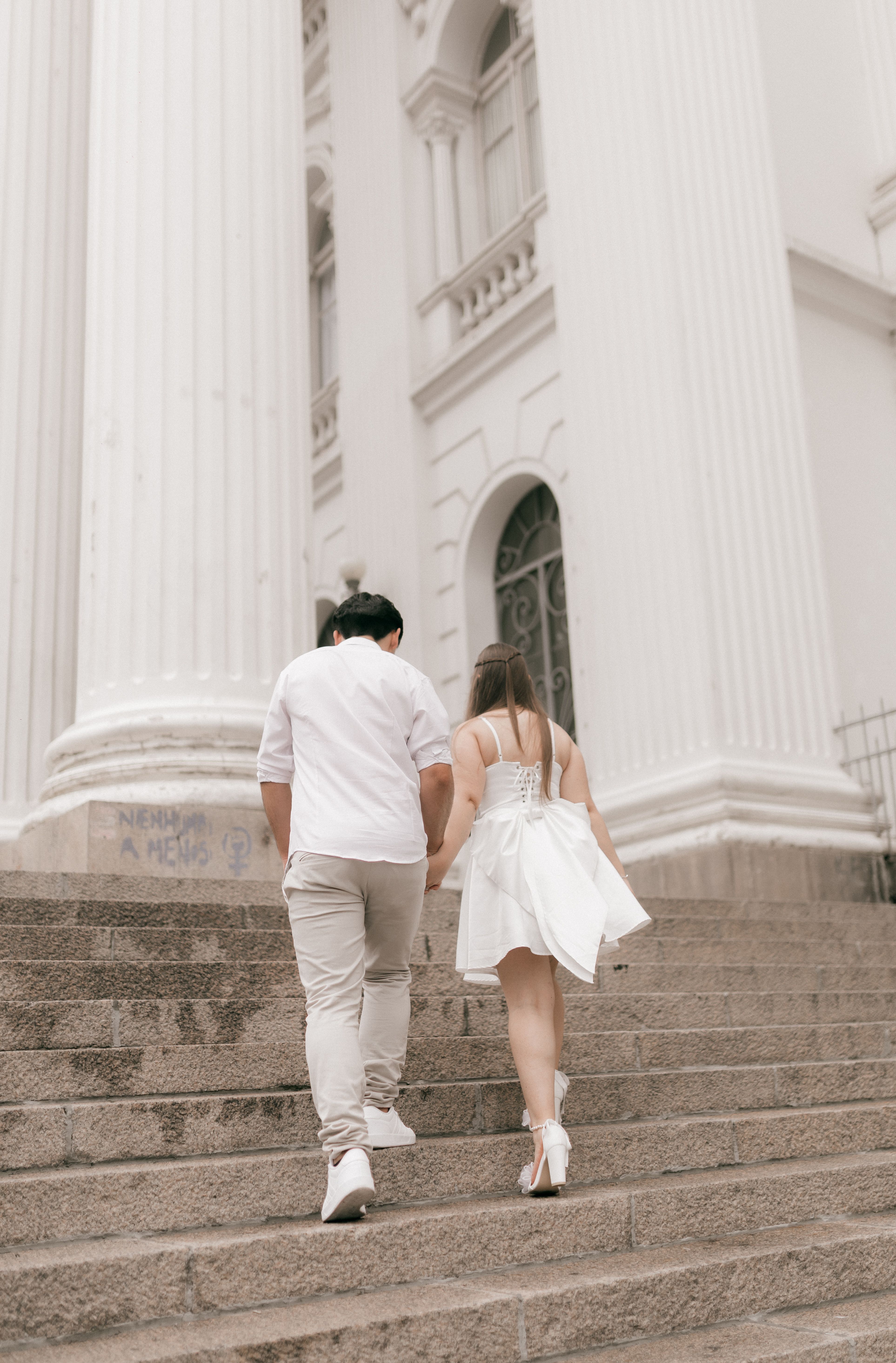 Elegant Couple Walking Up Historic Building Steps · Free Stock Photo