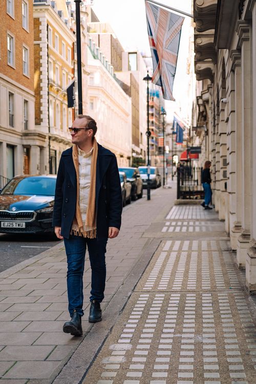 Free Adult man in warm attire walking down a London street on a crisp fall day. Stock Photo