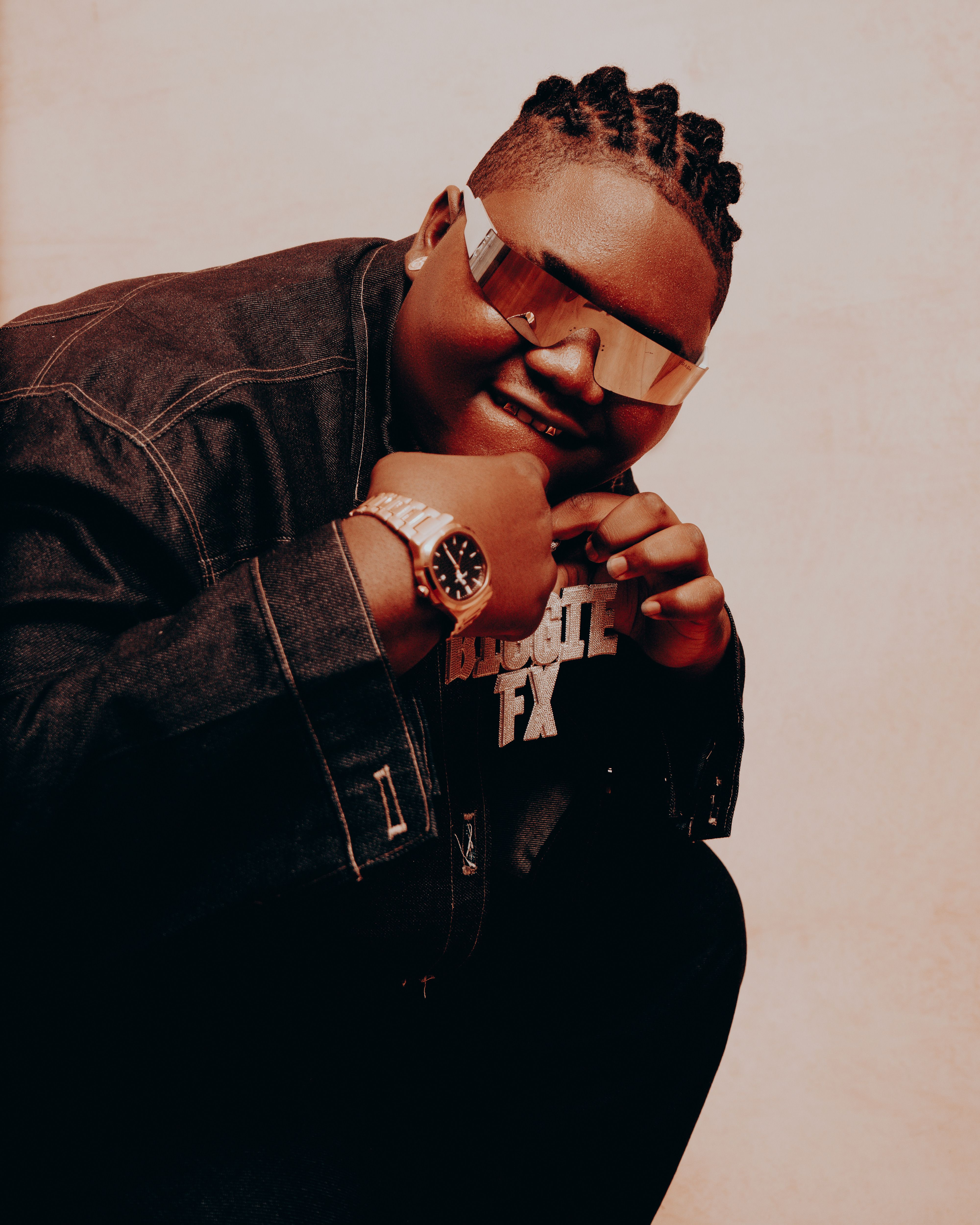Cool portrait of a stylish person wearing denim, sunglasses, and jewelry, exuding confidence.