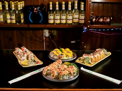 A selection of colorful sushi platters displayed on a restaurant bar, showcasing exquisite Japanese cuisine.