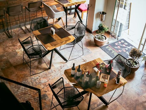 Aerial view of a rustic restaurant interior showcasing elegant table settings and warm decor.