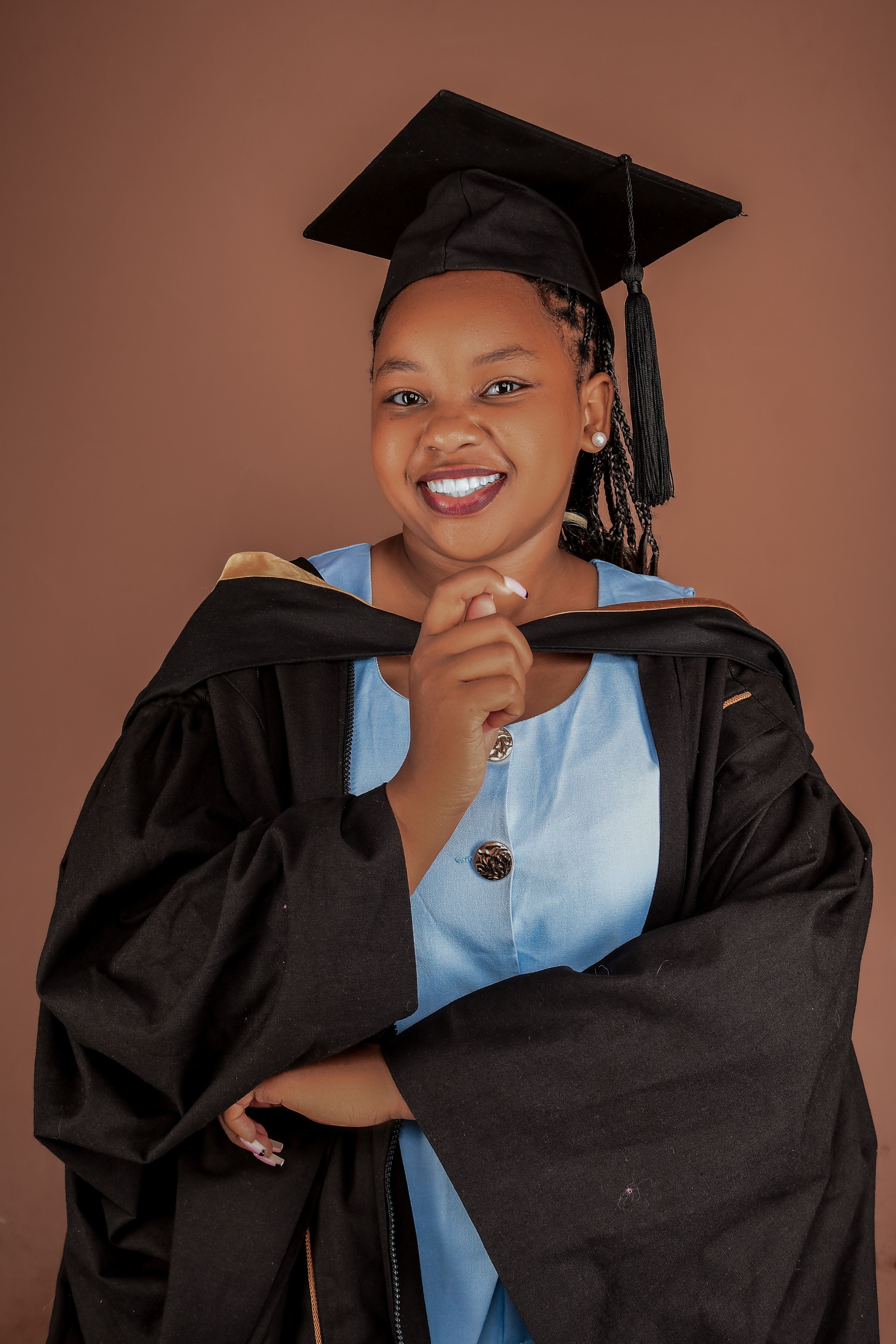 Joyful Graduate in Cap and Gown Portrait · Free Stock Photo