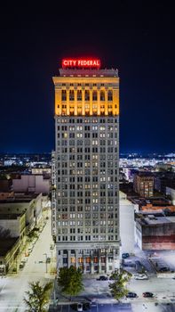 Aerial night view of the illuminated City Federal Building in Birmingham, Alabama.