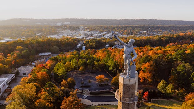 Aerial shot of the famous Vulcan statue overlooking Birmingham's fall foliage.