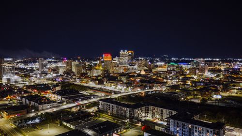 Free Stunning aerial night view of Birmingham, Alabama with illuminated cityscape and skyscrapers. Stock Photo