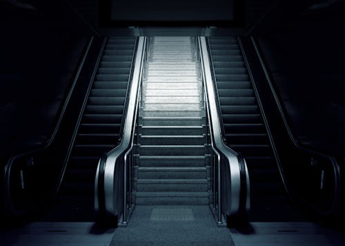 Grey and Black Escalator on Dimmed Place