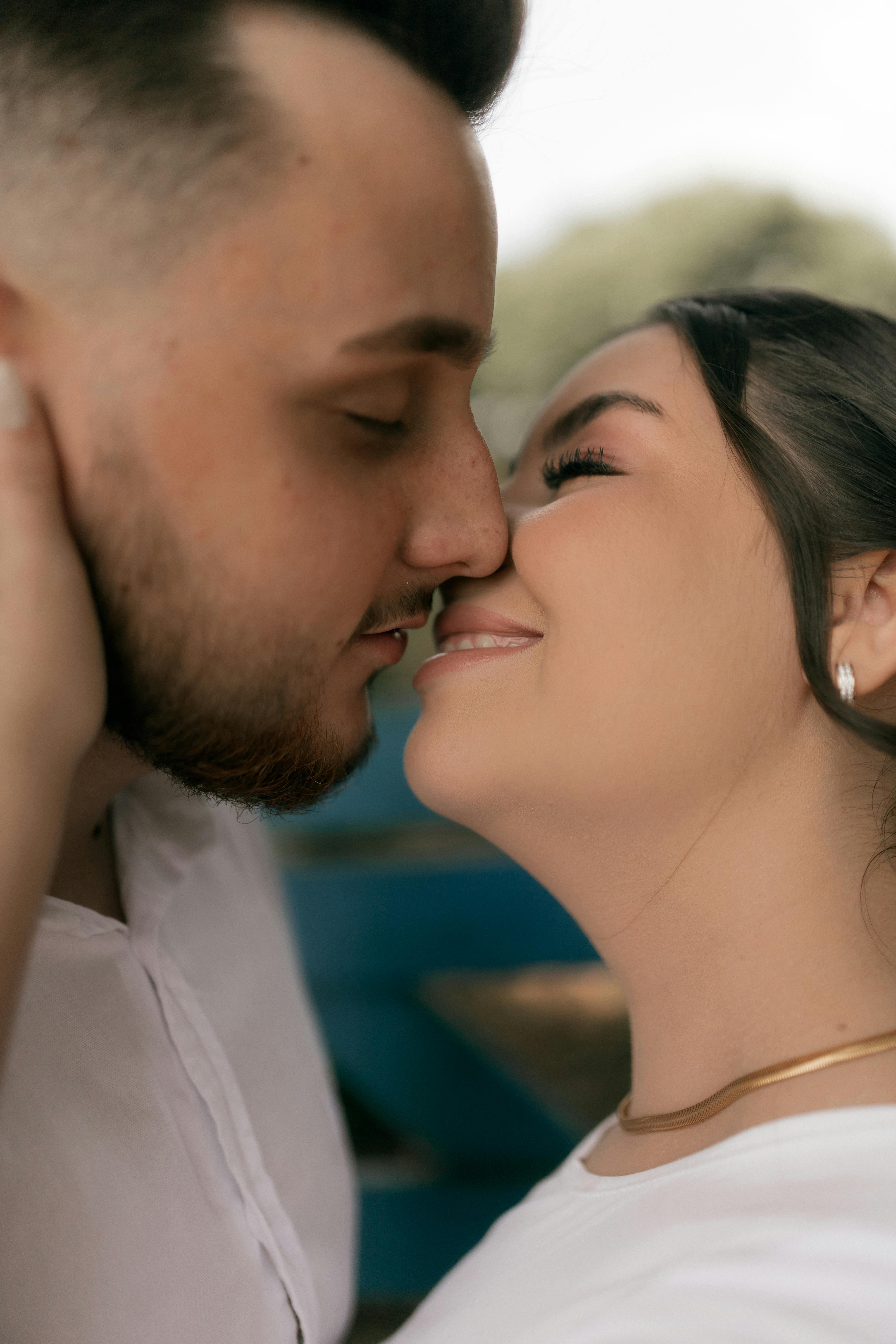 Romantic moment of a couple embracing closely, sharing affection outdoors.