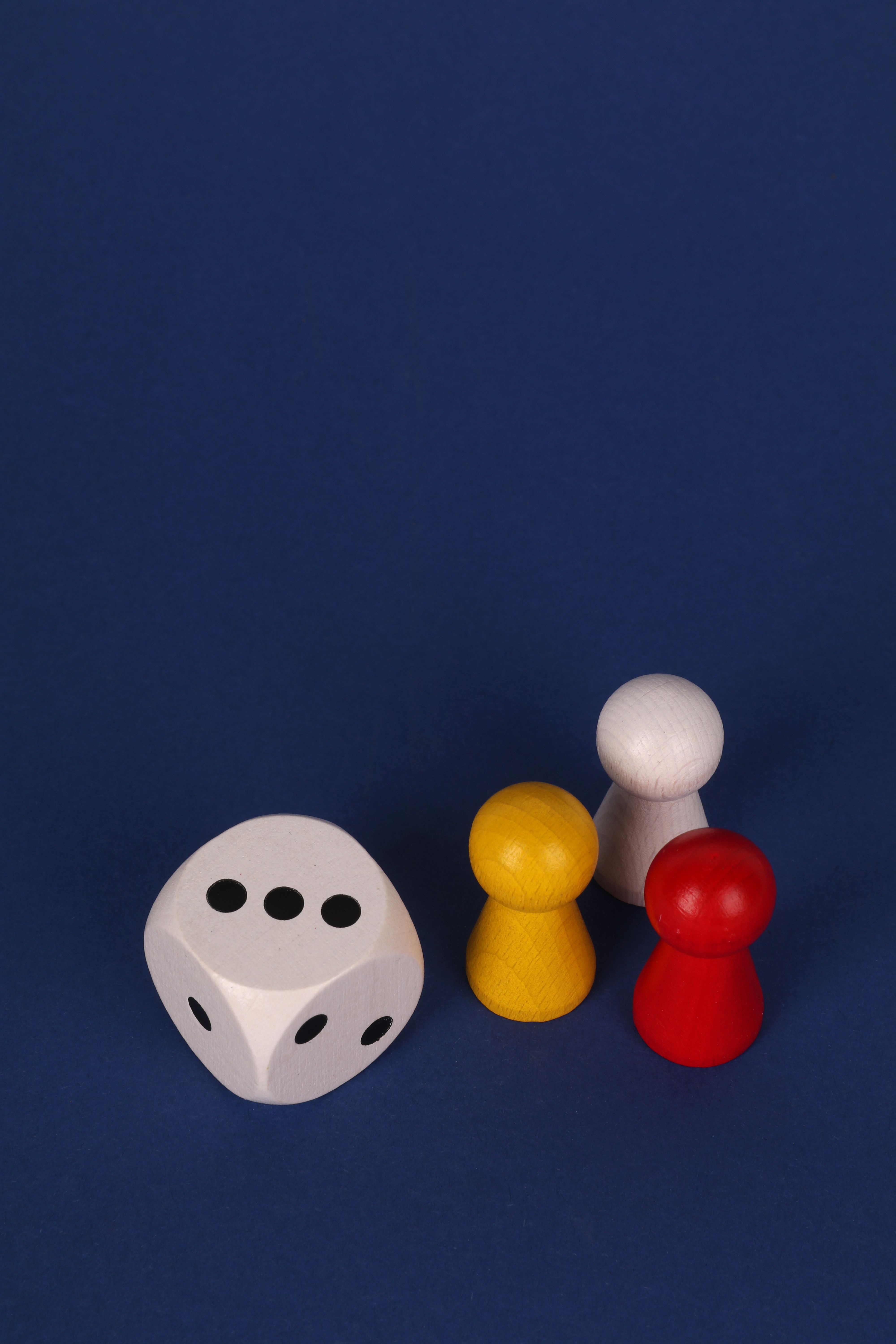 Vivid board game pieces and dice on blue backdrop, perfect for family game night inspiration.