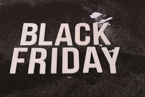 Free Bold 'Black Friday' text on a textured dark background, ideal for promotions. Stock Photo