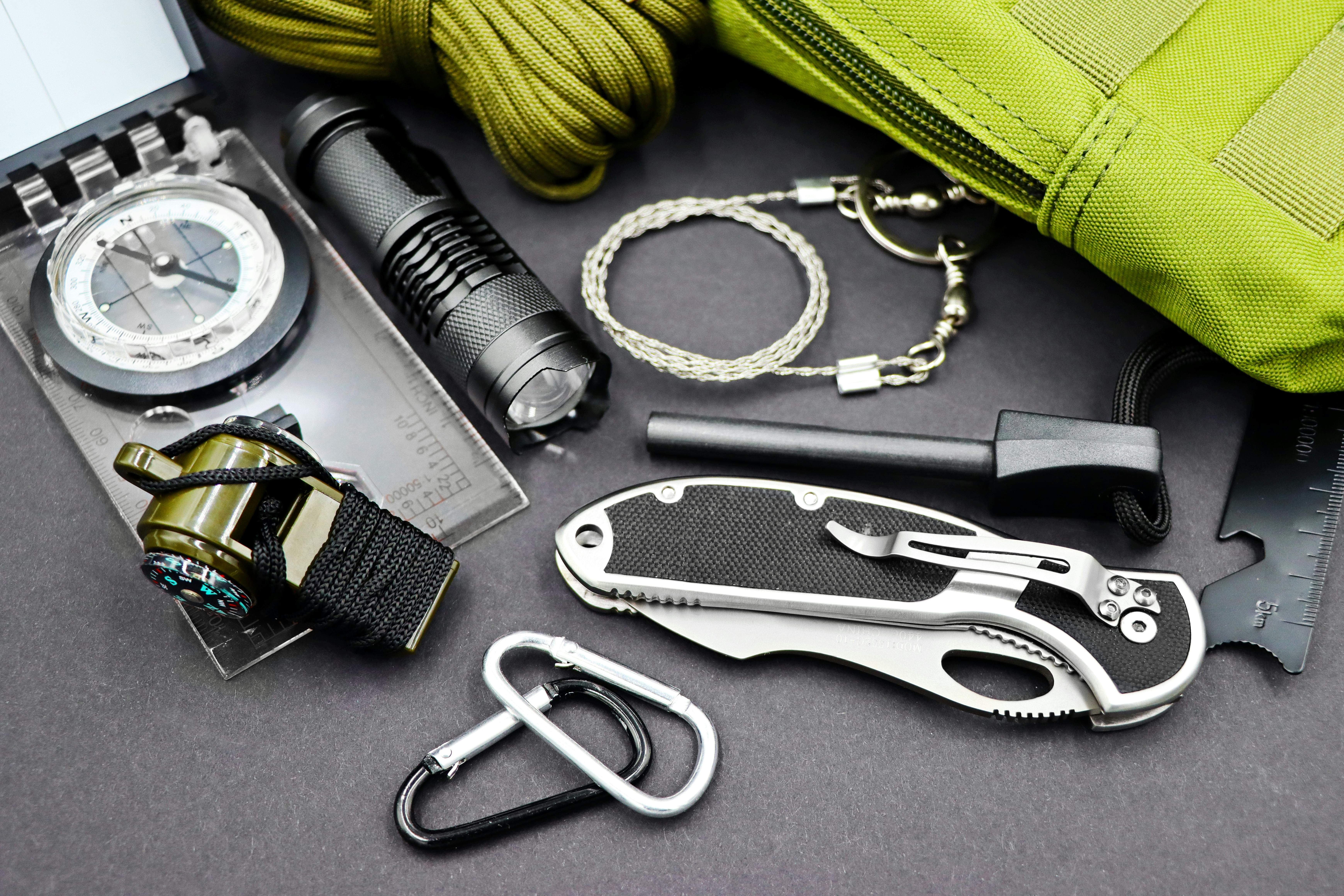 A comprehensive layout of essential survival tools including compass, flashlight, and knife, perfect for outdoor adventures.