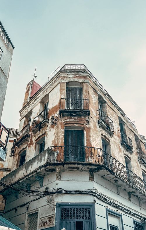 Free A vintage, weathered building showcasing historic architecture with ornate balconies. Stock Photo