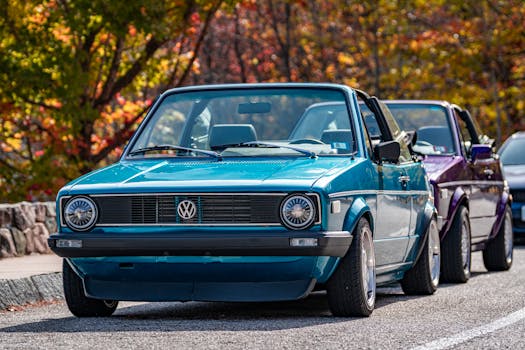 A vibrant scene of classic blue and purple Volkswagen convertibles parked in autumn setting.