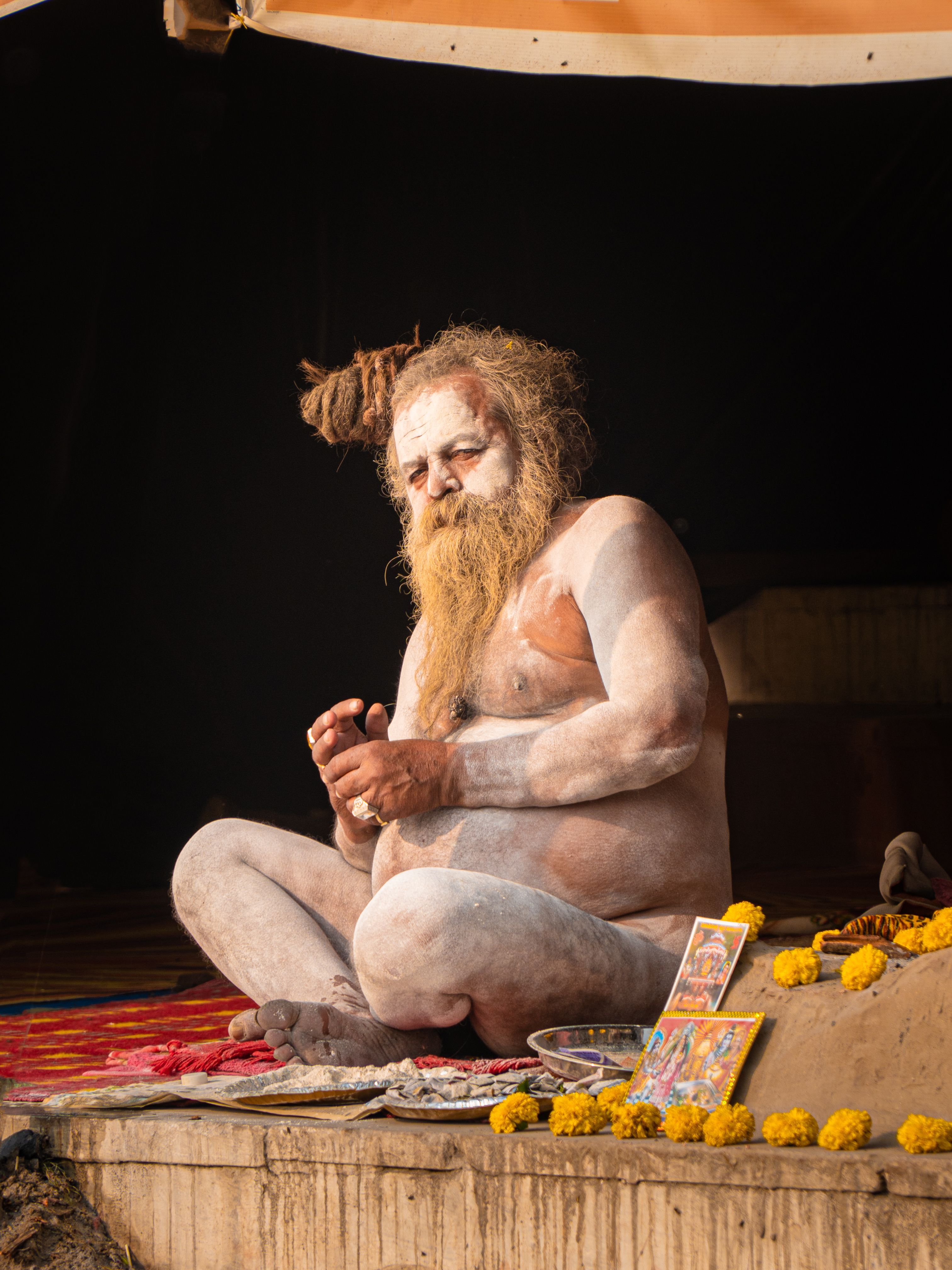A Naga Sadhu engrossed in meditation during a pilgrimage in Varanasi, India.