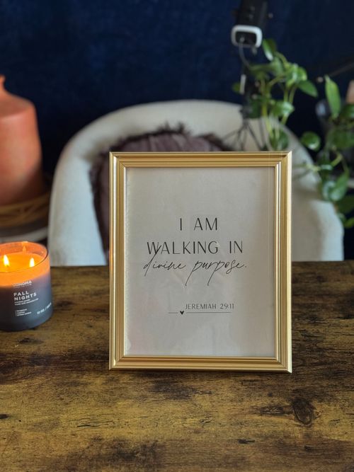 Free Gold-framed inspirational wall art featuring Jeremiah 29:11 with candle backdrop, ideal for cozy decor. Stock Photo