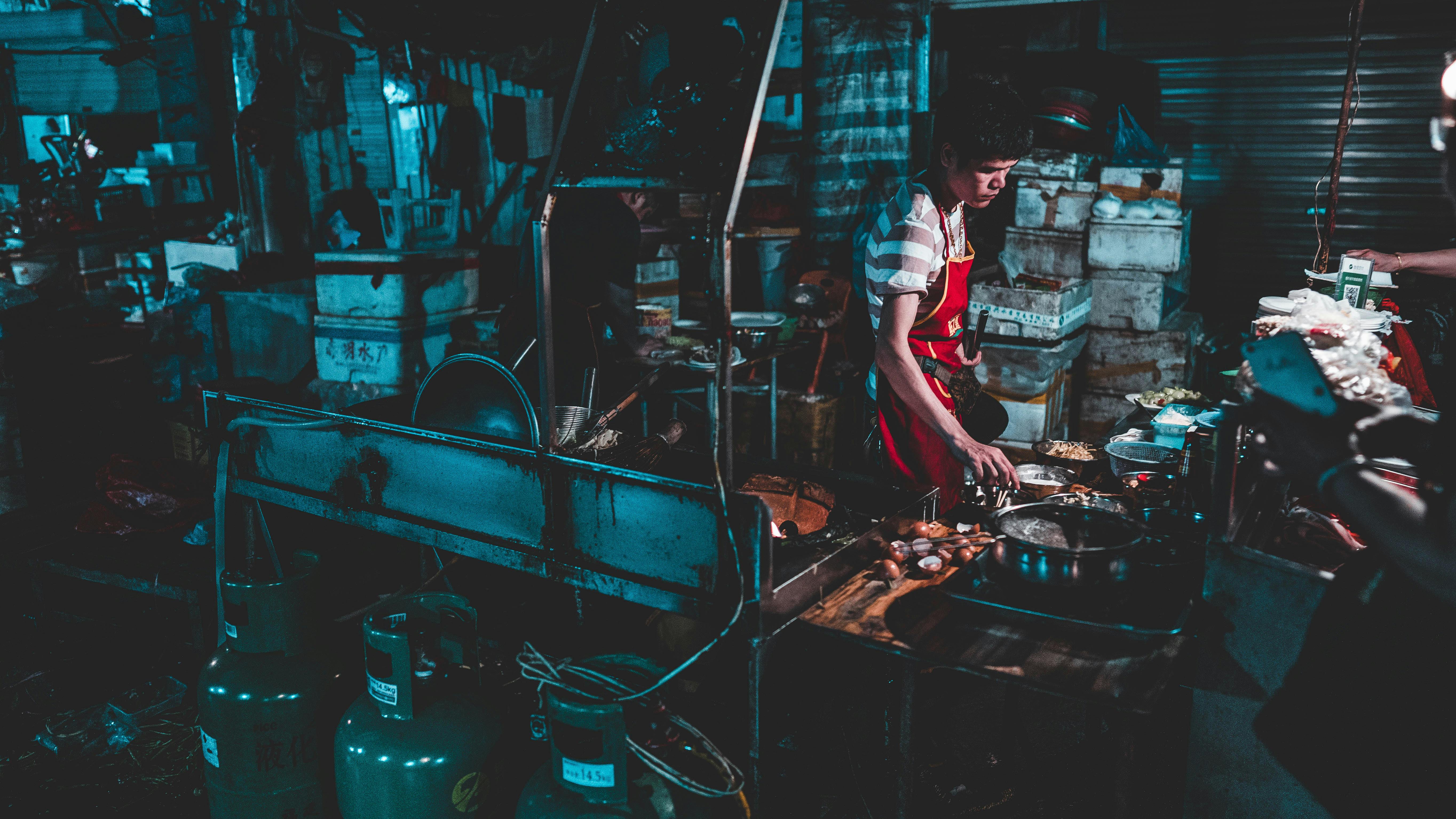 man cooking near pots