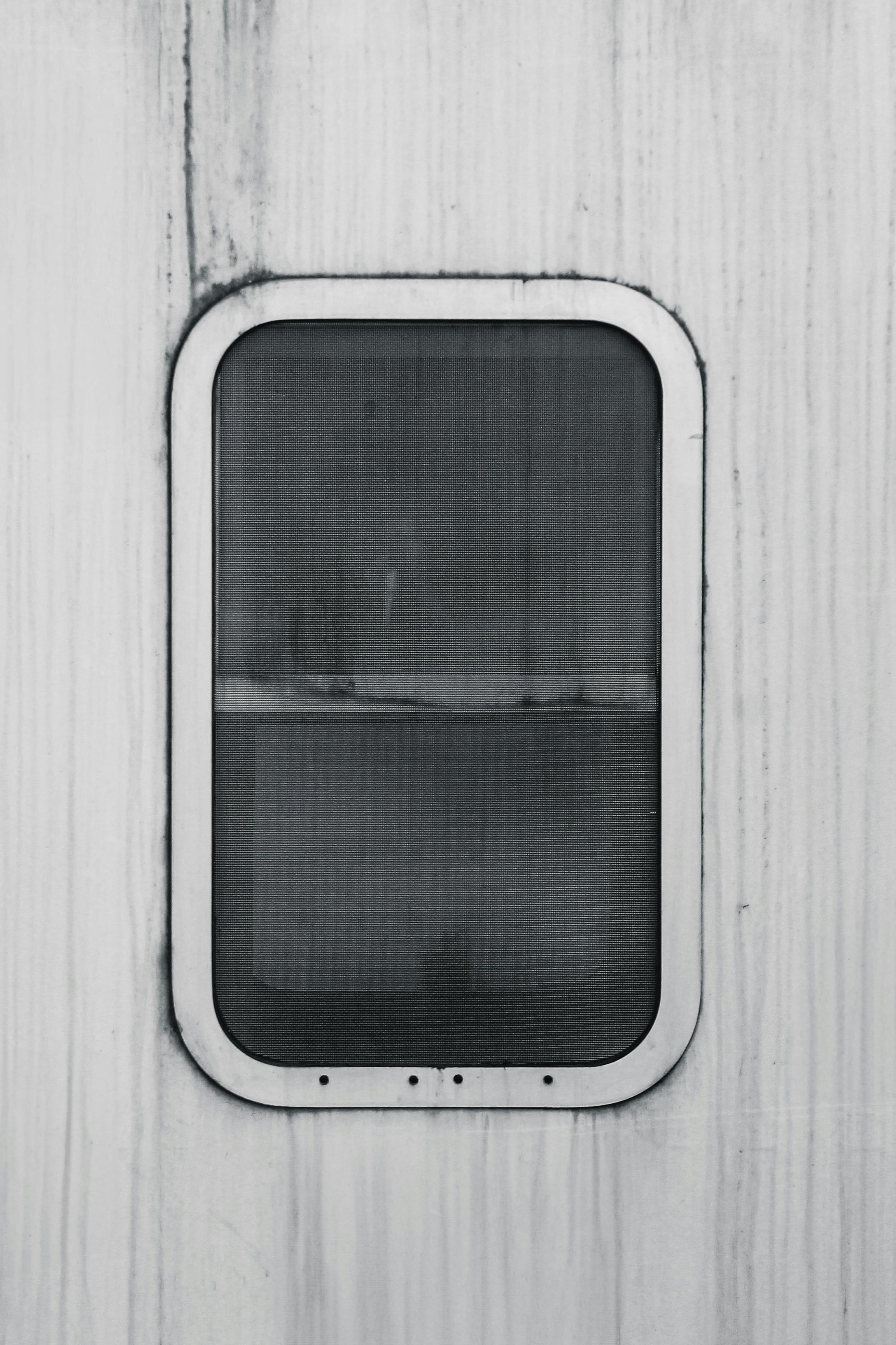 grátis Imagem minimalista em preto e branco de uma janela em uma parede texturizada, criando uma estética moderna. Foto profissional