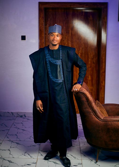 Free Portrait of a man wearing traditional Nigerian agbada in an indoor setting. Stock Photo