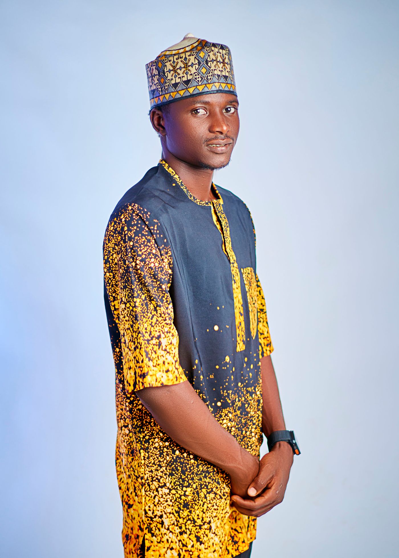 Refined West African menswear in a formal portrait