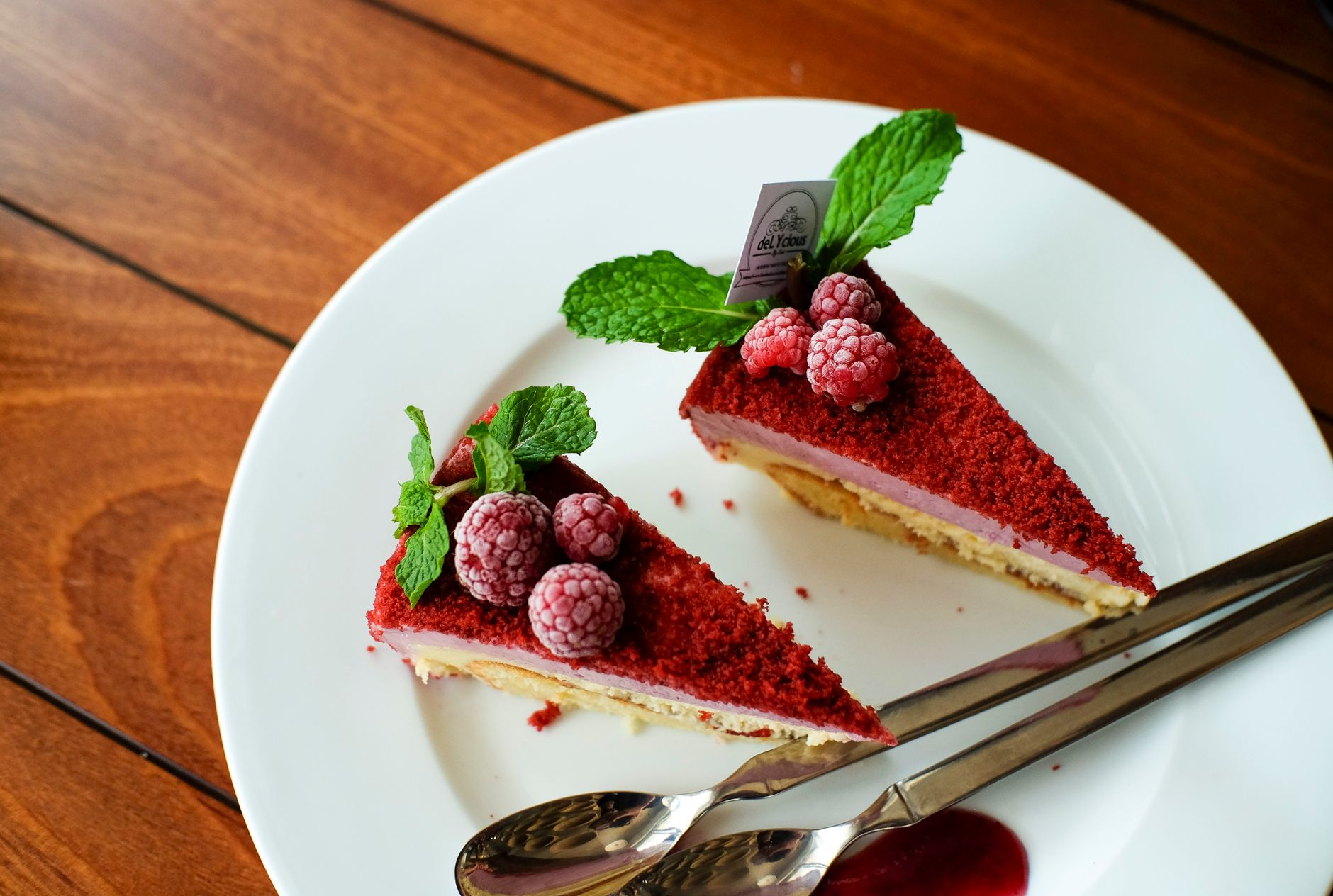 Red Velvet Bourbon Cheesecake Bars stacked on white plate