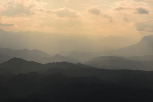 Free Peaceful view of misty mountains during sunrise, showcasing natural beauty and tranquility. Stock Photo