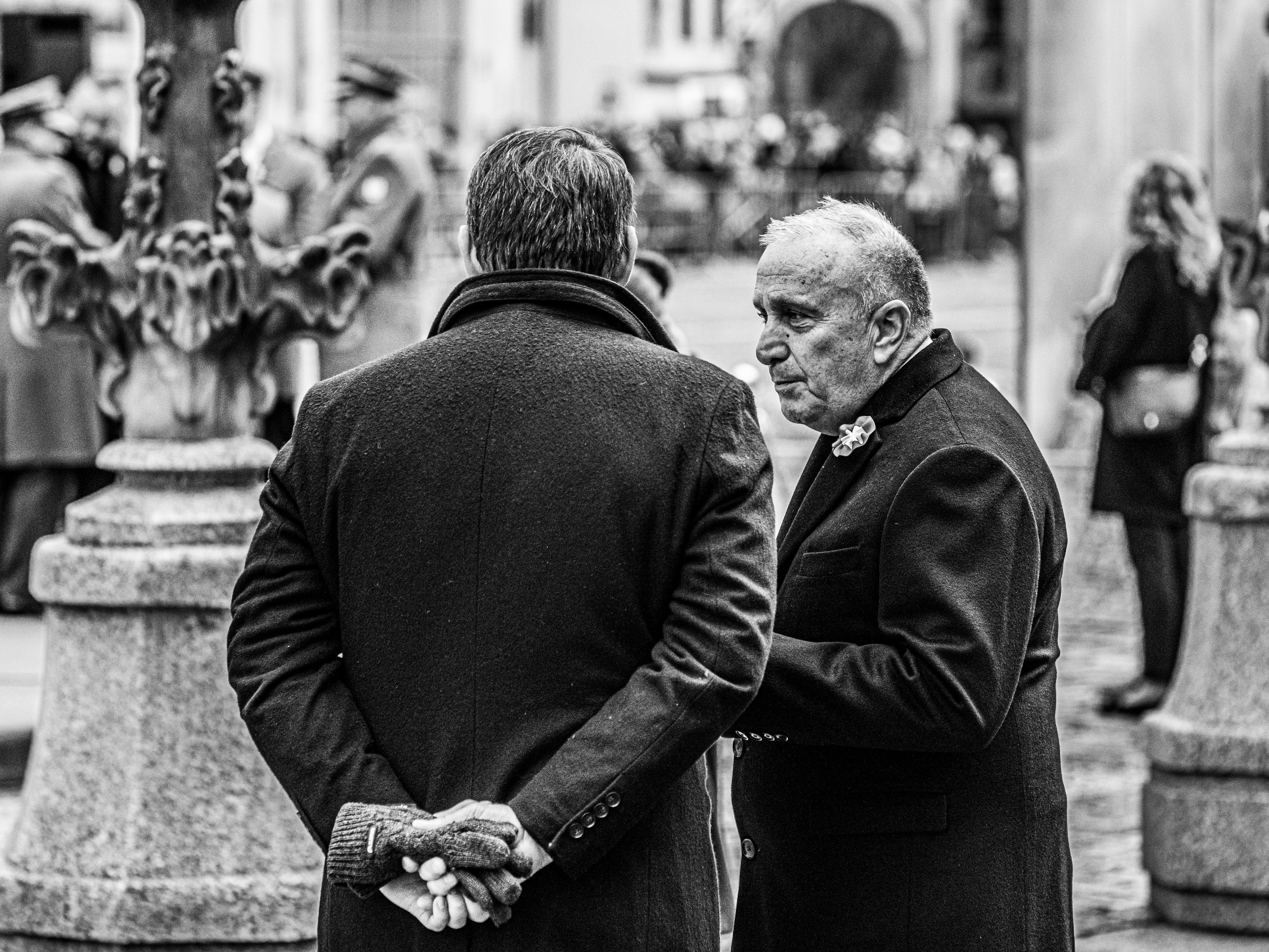 Two Men in Conversation at Outdoor Event · Free Stock Photo