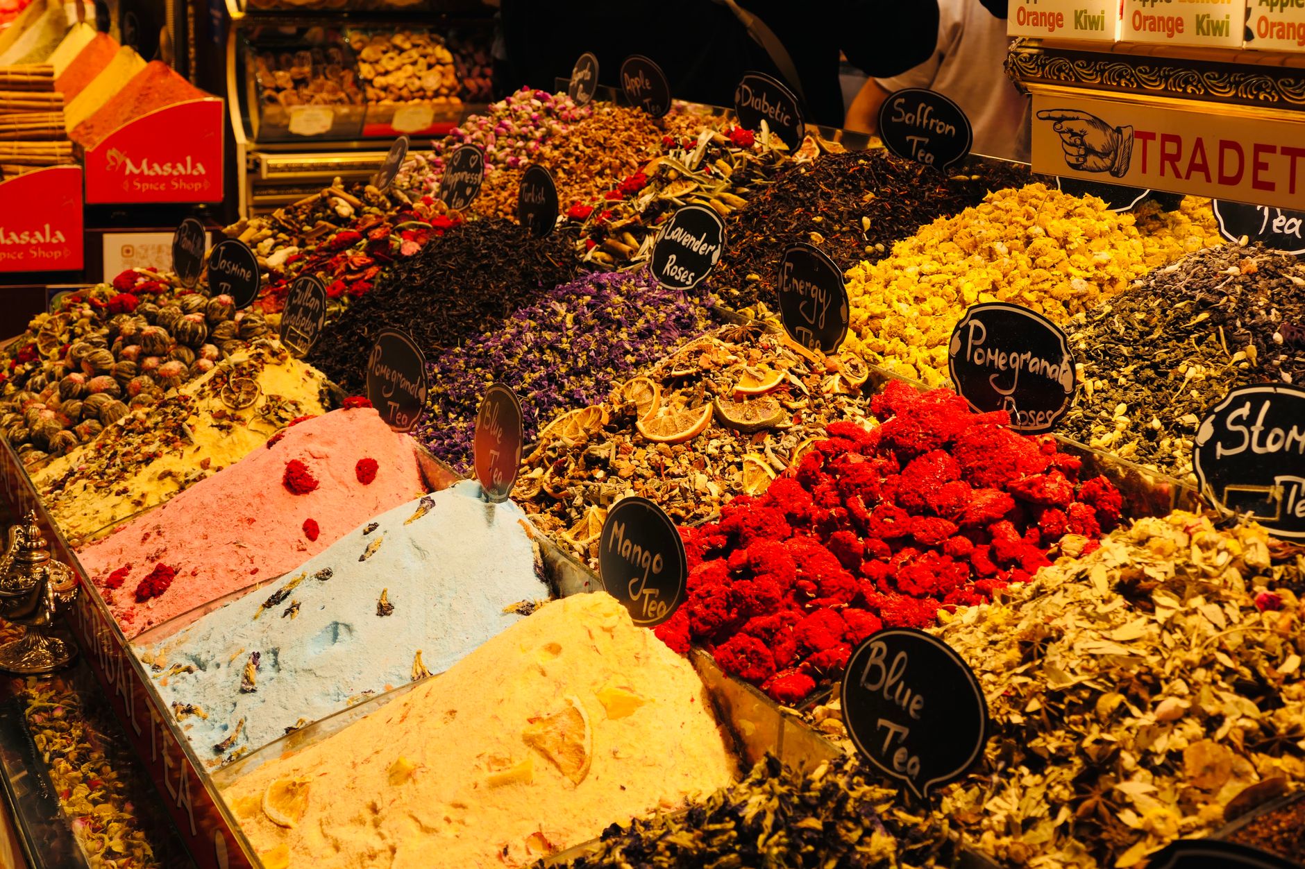 Colorful spices and teas displayed at a traditional market stall.