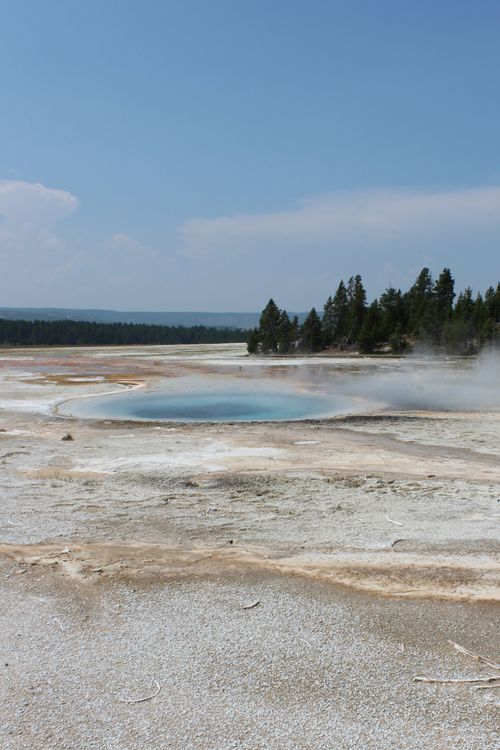 Free Stunning geothermal pool with steam in Yellowstone National Park landscape. Stock Photo