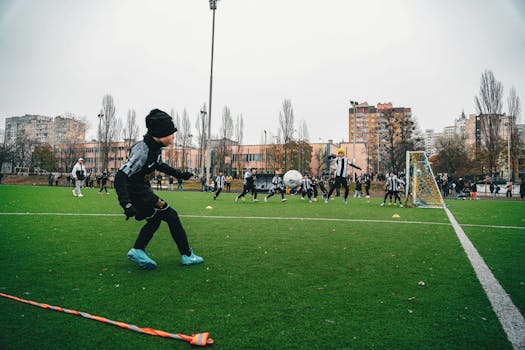 Kids playing soccer on an outdoor field in Kyiv, Ukraine, showcasing teamwork and sportsmanship.