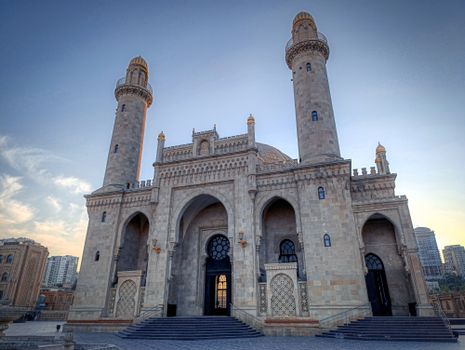 Magnificent view of the Taza Pir Mosque in Baku at sunset, showcasing intricate architectural details.
