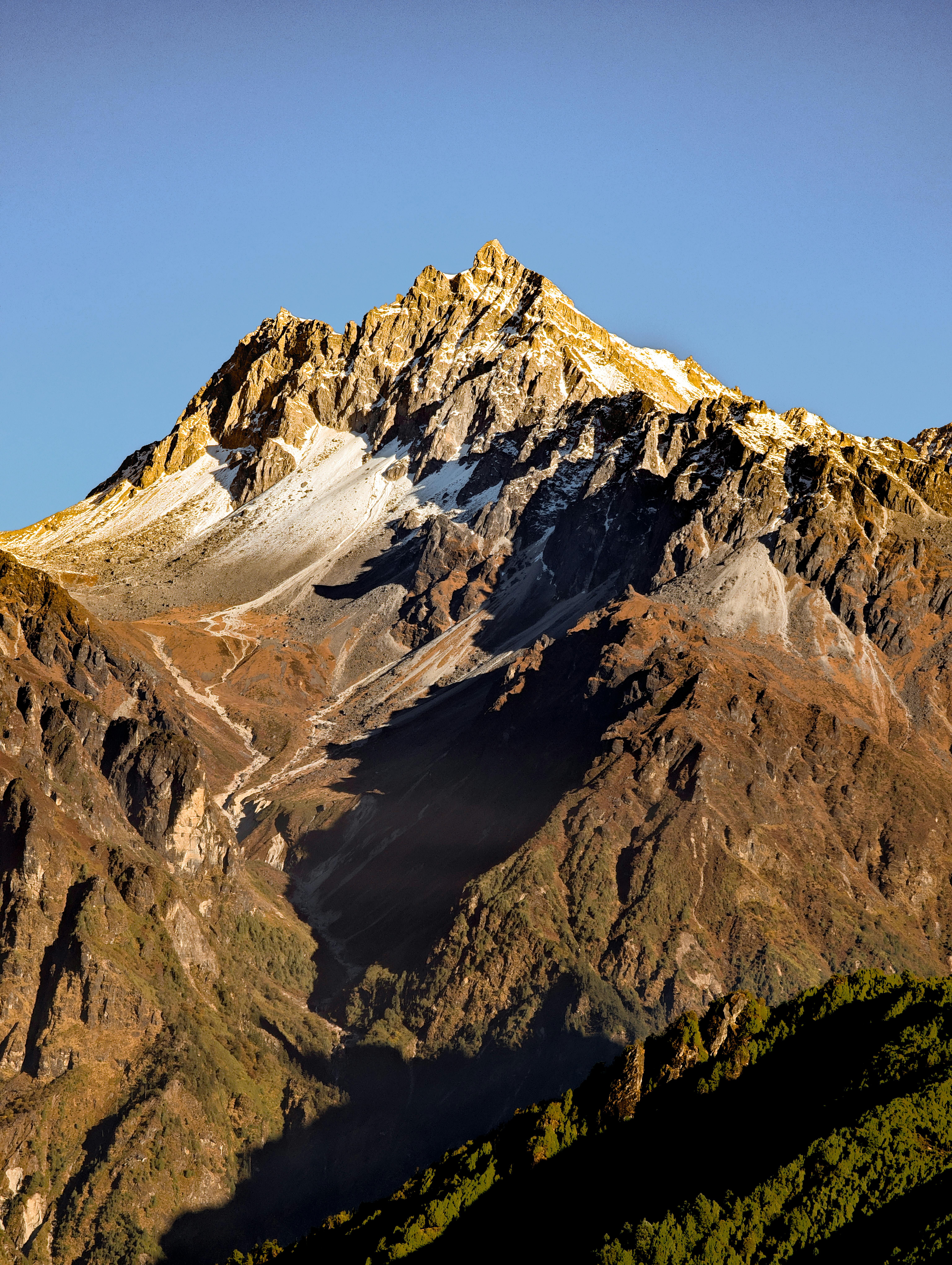 Stunning view of a snow-capped mountain peak in Helambu, Nepal at sunset.