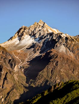 Stunning view of a snow-capped mountain peak in Helambu, Nepal at sunset.