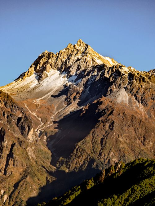 Free Stunning view of a snow-capped mountain peak in Helambu, Nepal at sunset. Stock Photo