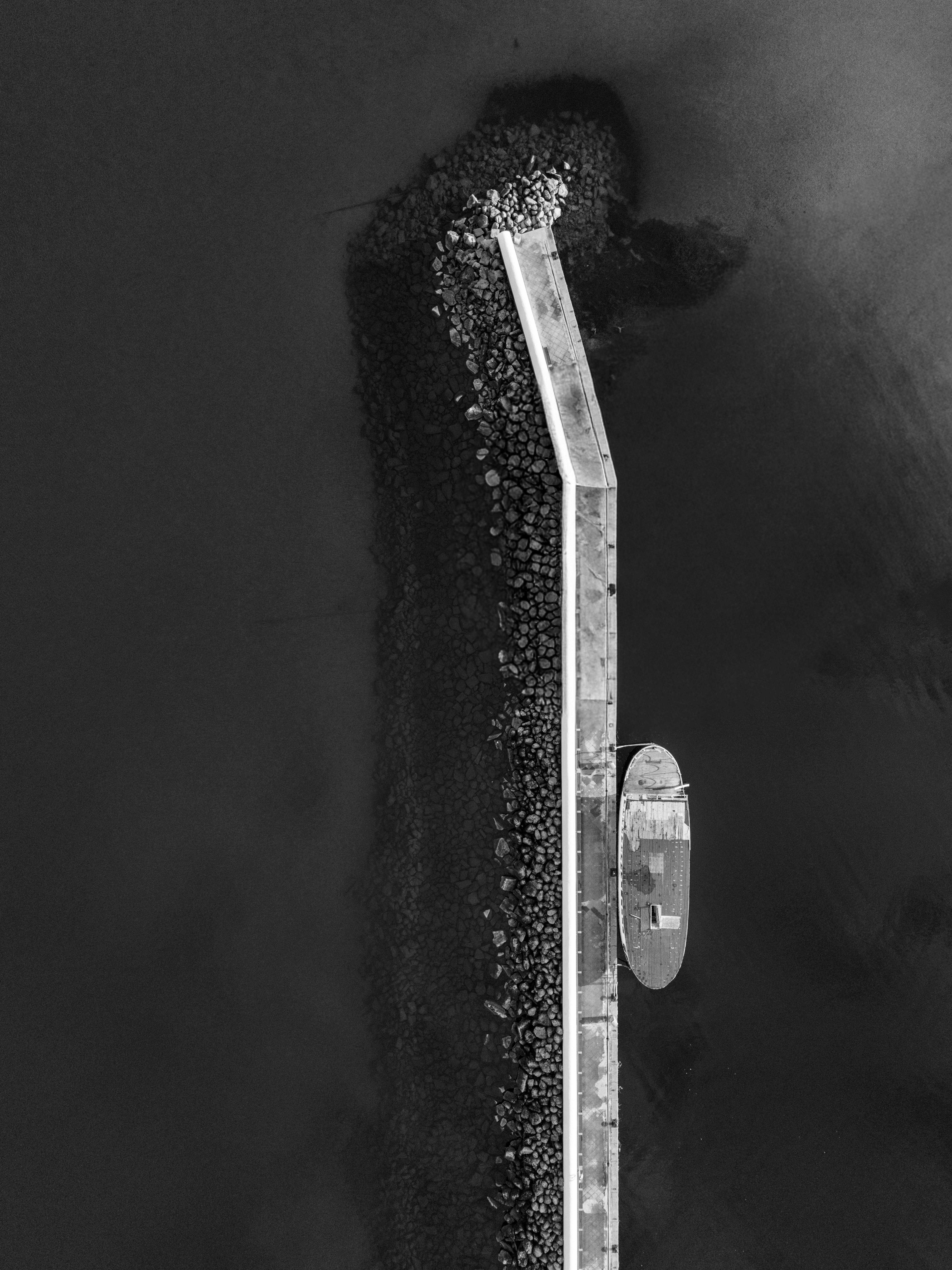 Free A striking aerial view of a pier in Jönköping, Sweden captured in black and white. Stock Photo