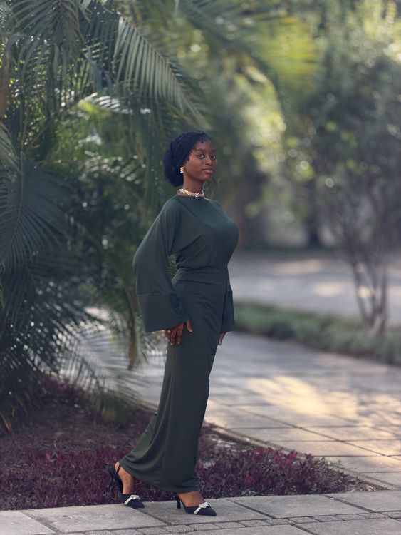 Elegant Woman in Green Dress Posing Outdoors · Free Stock Photo