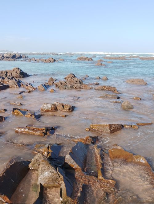 Free Explore the stunning rocky shoreline of Casablanca, Morocco with clear blue waters and vibrant skies. Stock Photo