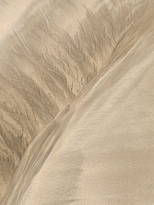 Free Intricate sand patterns at low tide on a Casablanca beach, showcasing nature's artistry. Stock Photo
