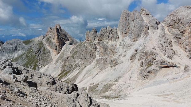 Captivating view of rugged peaks in the Dolomites under a clear summer sky.