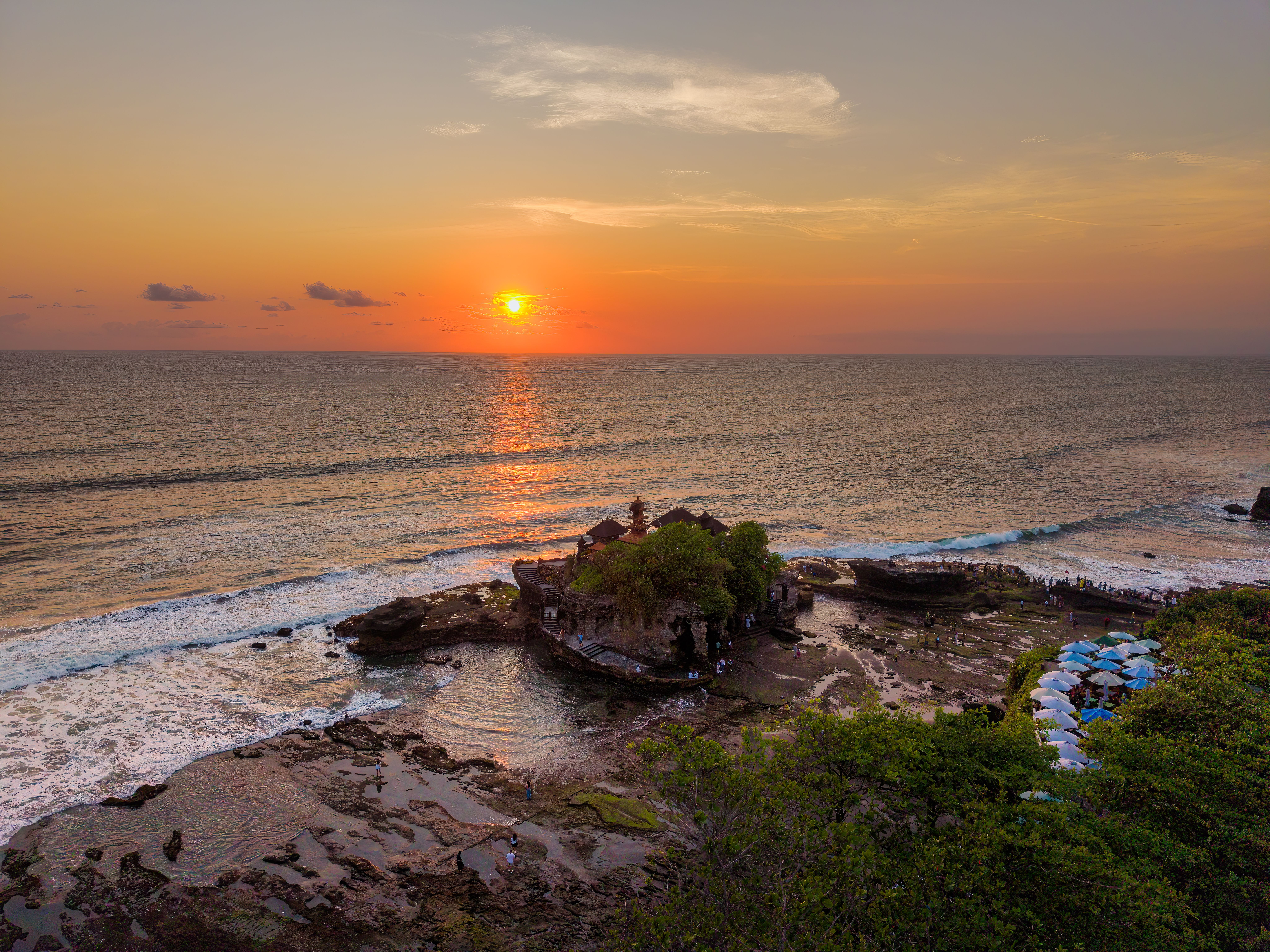 Tanah Lot Temple silhouetted at sunset on its rocky outcrop along Bali's southwest coast in April