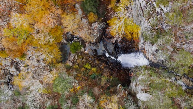 A stunning aerial view of a waterfall surrounded by colorful autumn foliage in Dayton, Tennessee.