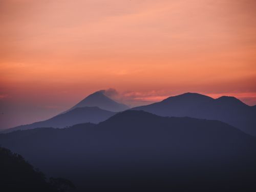 Free A tranquil scene of Telica Volcano at sunset, showcasing dramatic skies and serene mountain ranges. Stock Photo