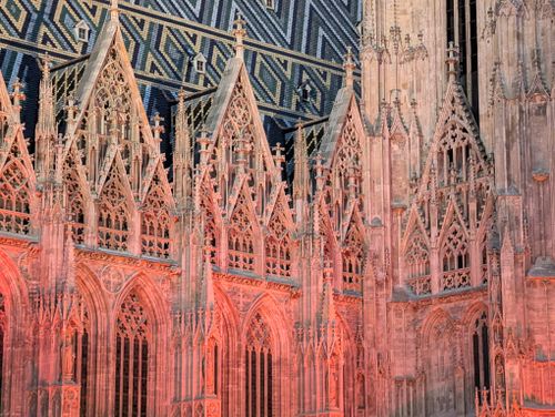 Free St. Stephen's Cathedral facade in Vienna glows under dramatic lighting, showcasing Gothic architecture. Stock Photo