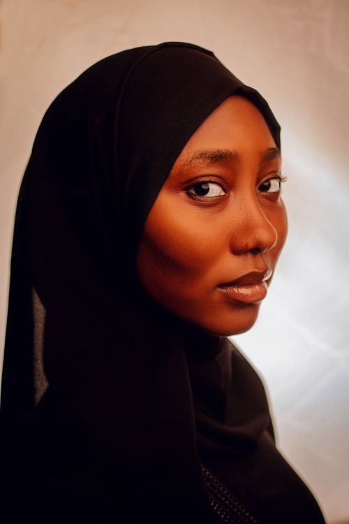 Free Elegant portrait of an adult woman wearing a black hijab in soft lighting. High-quality close-up. Stock Photo