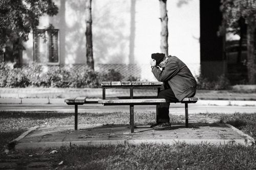 Free A senior man in solitude, deep in thought, sitting at a park bench in Eskişehir. Stock Photo