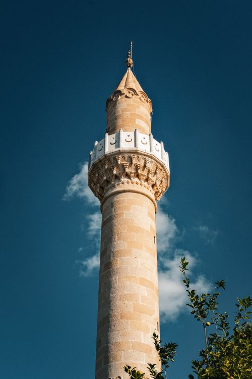 Free A beautifully detailed minaret tower set against a clear blue sky in Muğla, Türkiye. Stock Photo