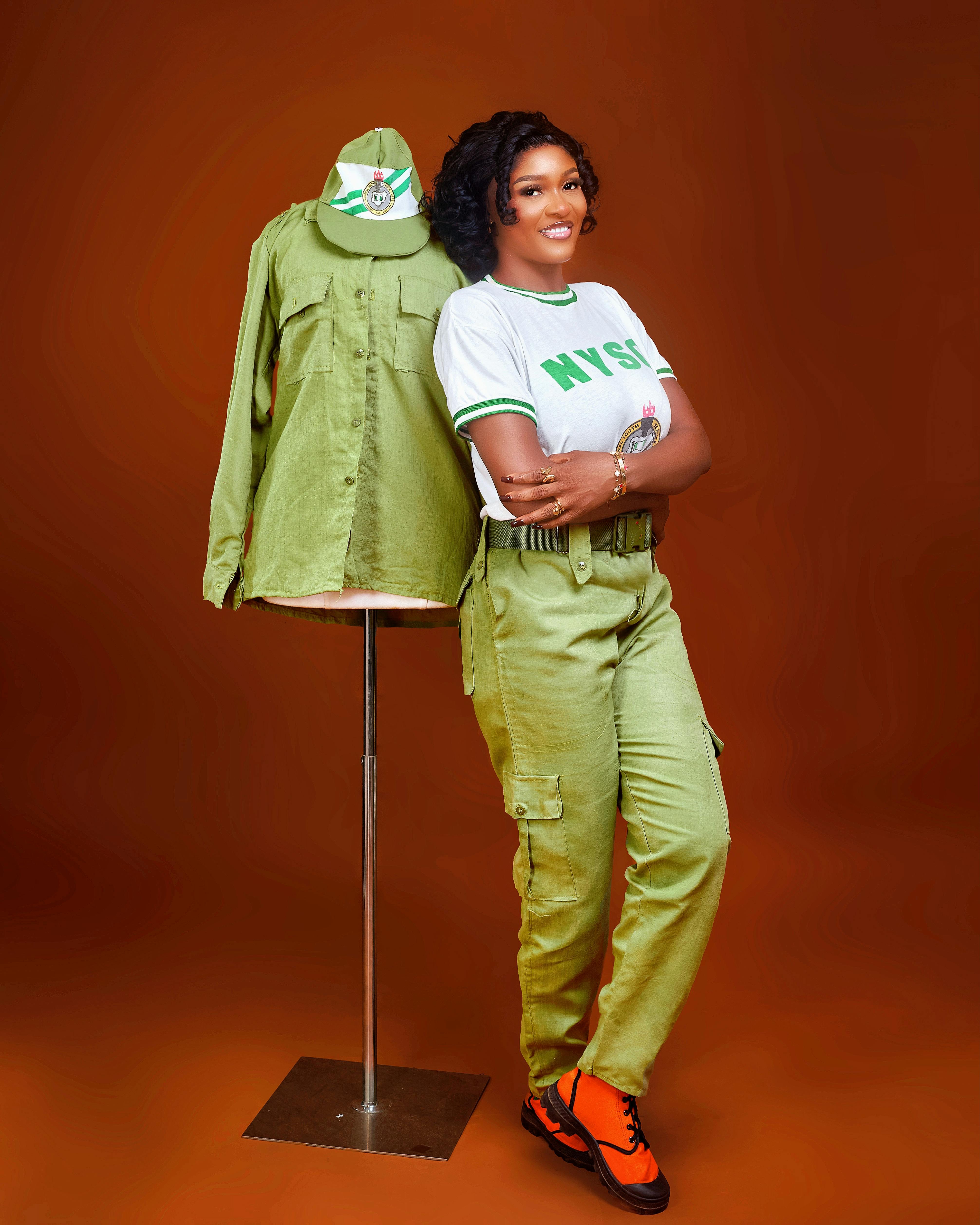 NYSC Member Posing with Uniform on Mannequin