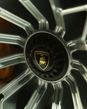 Detailed close-up of a luxury car wheel rim with metallic finish and intricate design.