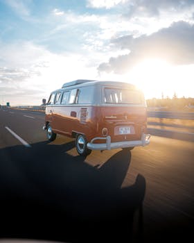 A classic Volkswagen van driving on a highway in Ankara, Türkiye at sunrise.