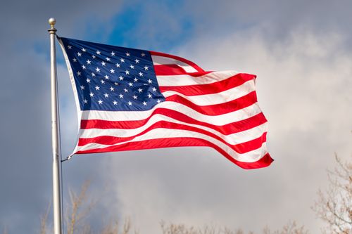 Free A bright, vivid display of the American flag waving against a blue sky in Canonsburg, Pennsylvania. Stock Photo
