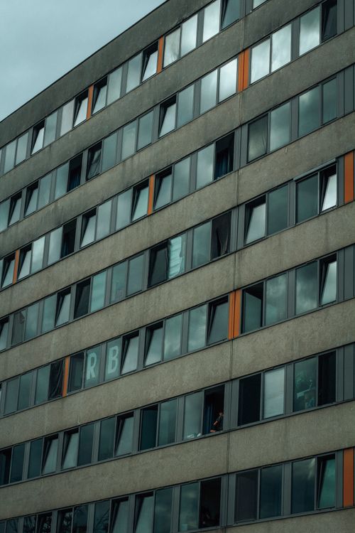 Free Urban apartment facade with reflected cloudy sky in Budapest, Hungary. Stock Photo